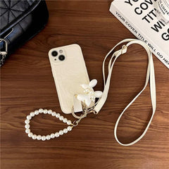 Camellia Flower and Puppy Pearl Charm Leather Crossbody Lanyard Phone Case for iPhone 15 Series