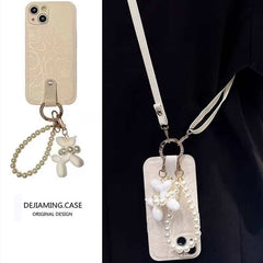 Camellia Flower and Puppy Pearl Charm Leather Crossbody Lanyard Phone Case for iPhone 14 Series